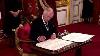 King Charles Prompts Aide To Take Pen Away